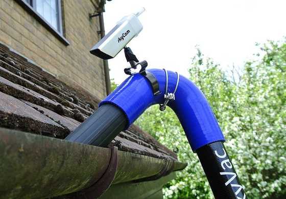 High-reach SkyVac gutter cleaning equipment in use